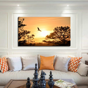 Eagle Flying Towards Sunset Canvas Art